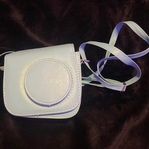 Instax Camera and Case. It is a n instax mini 7S. Only used a couple of times.